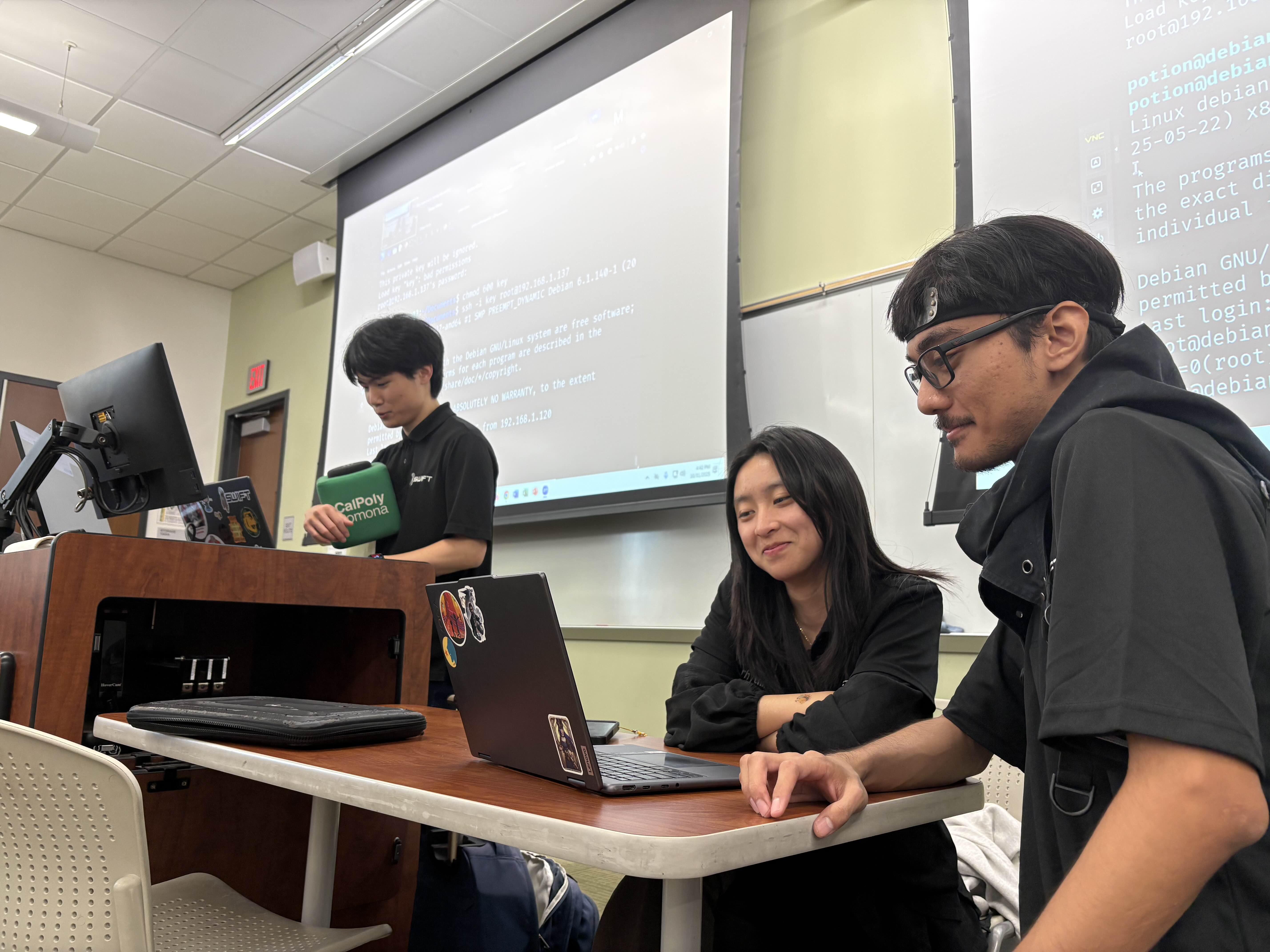 Going over the solutions for SCARE 2025 with some of the SWIFT intern board. It was Halloween so I have a Naruto headband on for my costume lol.